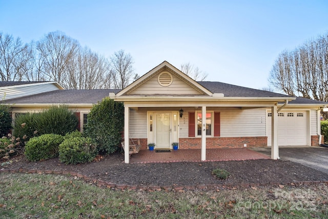 ranch-style home with a porch and a garage