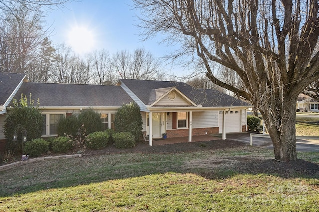 ranch-style house featuring a front yard, a porch, and a garage