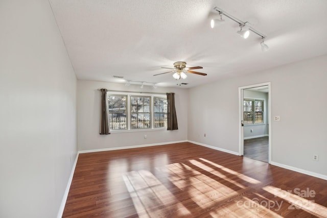 spare room featuring wood-type flooring, a textured ceiling, and ceiling fan