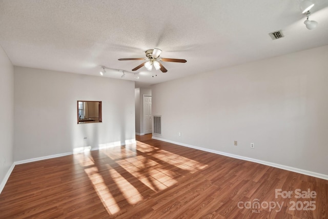 unfurnished room featuring hardwood / wood-style flooring, ceiling fan, and a textured ceiling