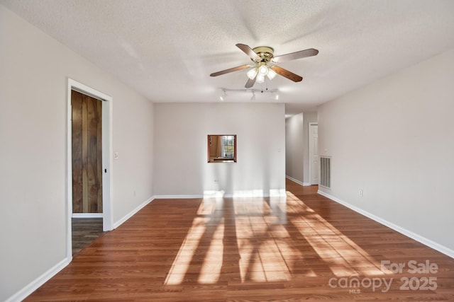 empty room featuring hardwood / wood-style floors, ceiling fan, and a textured ceiling