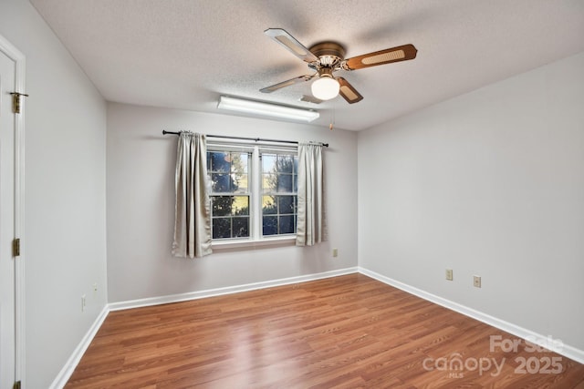 spare room with ceiling fan, hardwood / wood-style floors, and a textured ceiling