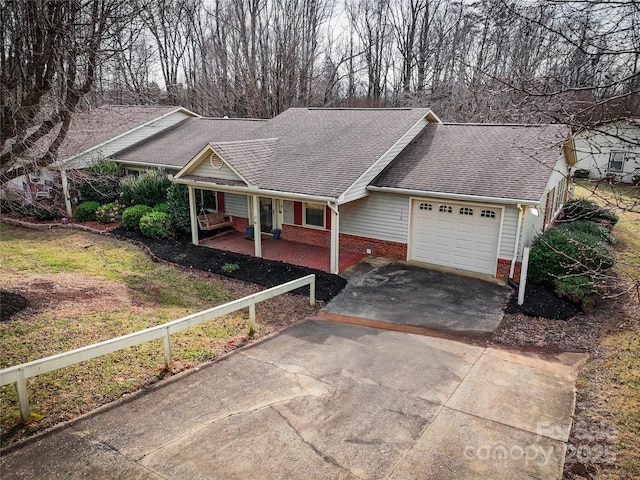 single story home featuring an attached garage, covered porch, brick siding, a shingled roof, and driveway