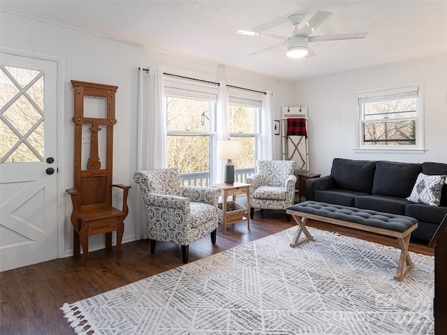 living room with ceiling fan and dark hardwood / wood-style flooring