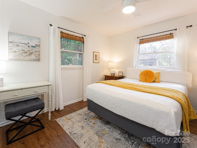 bedroom with dark hardwood / wood-style floors and ceiling fan