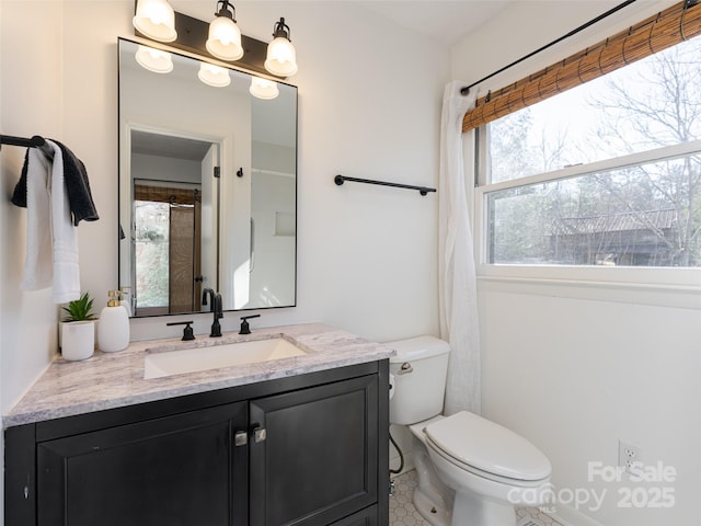 bathroom featuring tile patterned flooring, vanity, and toilet