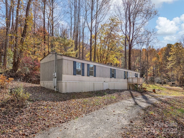 view of side of property featuring a wooden deck