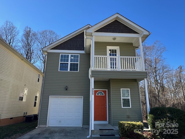 view of front facade featuring a garage and a balcony