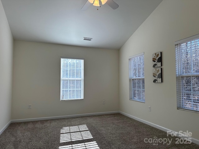 carpeted spare room featuring vaulted ceiling and ceiling fan