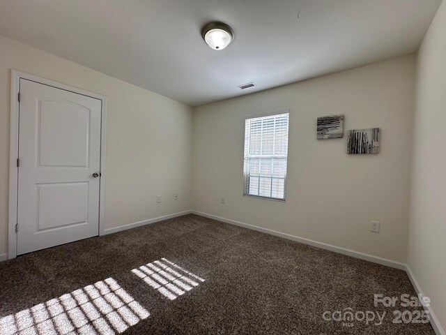 unfurnished room with carpet floors