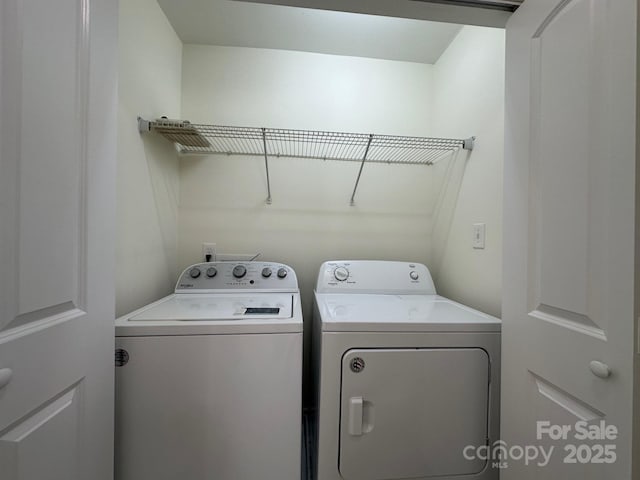 laundry room with washing machine and clothes dryer