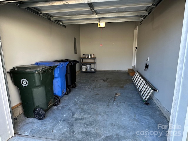 garage featuring electric panel and a garage door opener