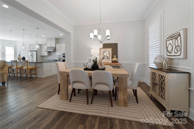 dining space featuring a notable chandelier, dark hardwood / wood-style flooring, and crown molding