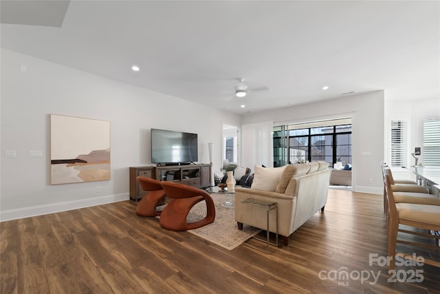 living room with ceiling fan and dark hardwood / wood-style floors