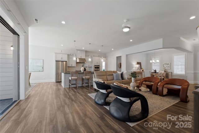 living room featuring hardwood / wood-style floors and ceiling fan