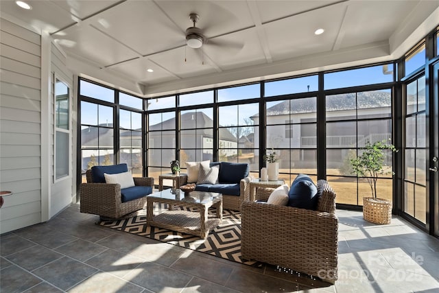 sunroom with ceiling fan and coffered ceiling