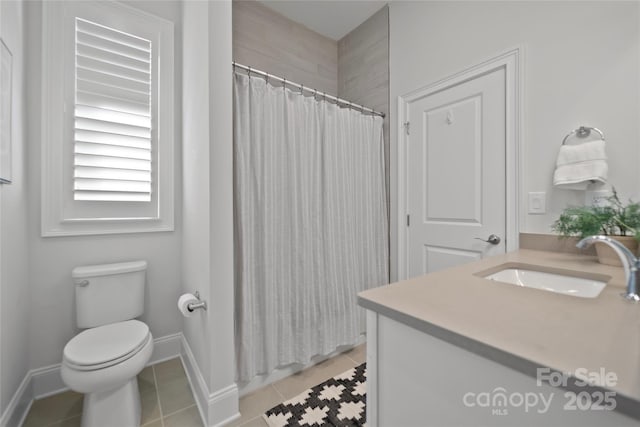 bathroom with a shower with shower curtain, vanity, tile patterned floors, and toilet