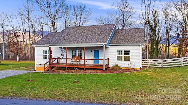 view of front of property with ceiling fan, a front lawn, and a deck