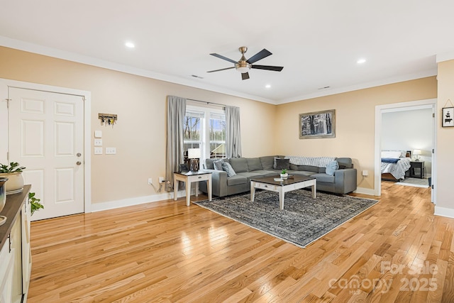 living room with ceiling fan, light hardwood / wood-style floors, and crown molding