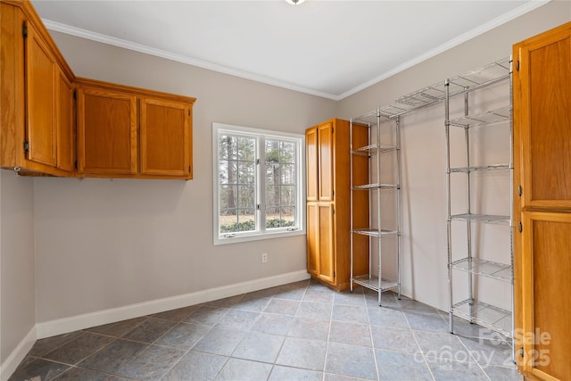 interior space featuring crown molding and baseboards