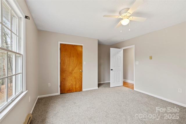 unfurnished bedroom with ceiling fan, baseboards, and carpet floors