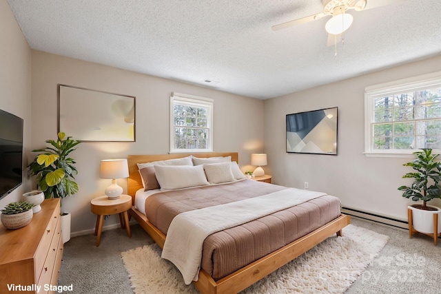 bedroom with visible vents, carpet, a textured ceiling, a ceiling fan, and a baseboard radiator