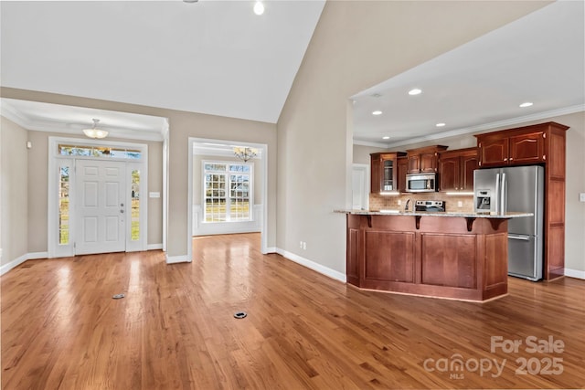 kitchen featuring backsplash, an inviting chandelier, dark hardwood / wood-style floors, and appliances with stainless steel finishes