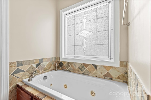 bathroom with a tub to relax in and a wealth of natural light