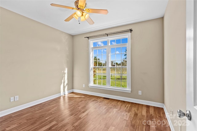 empty room with ceiling fan and light wood-type flooring