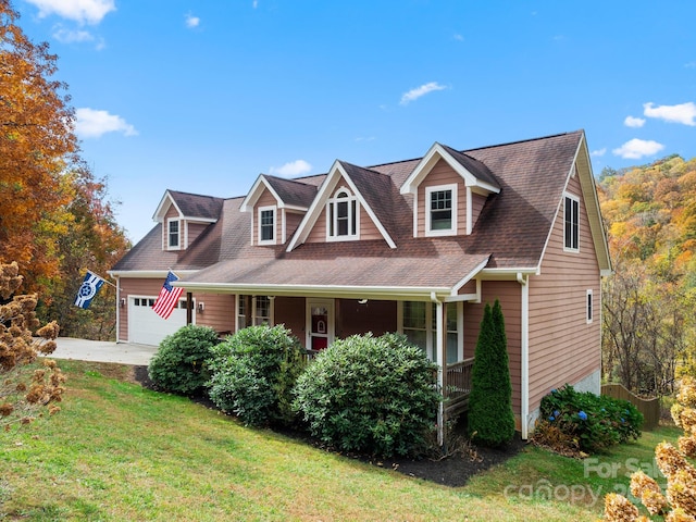 cape cod-style house with a front lawn, a porch, and a garage