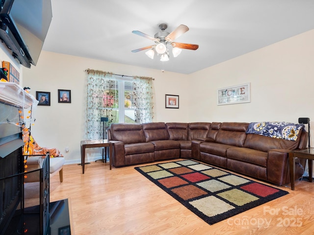 living room with wood-type flooring and ceiling fan