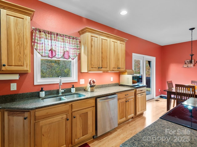 kitchen featuring sink, stainless steel dishwasher, plenty of natural light, pendant lighting, and light wood-type flooring