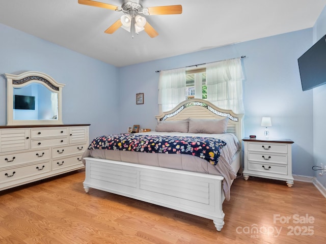 bedroom with light hardwood / wood-style floors and ceiling fan