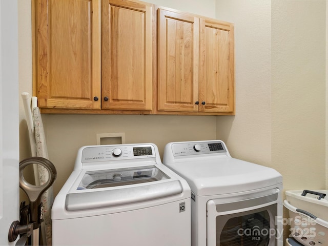 laundry area featuring cabinets and independent washer and dryer