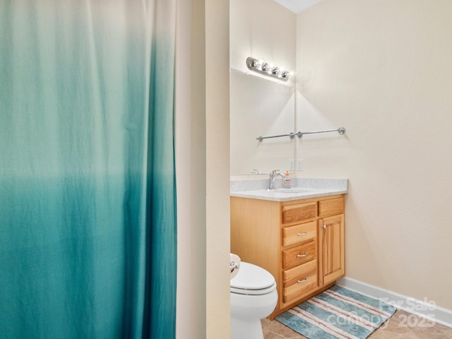 bathroom featuring tile patterned flooring, vanity, and toilet