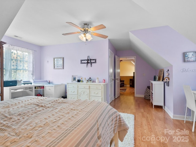 bedroom featuring ceiling fan, vaulted ceiling, and light wood-type flooring