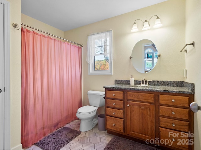 bathroom featuring tile patterned floors, vanity, and toilet