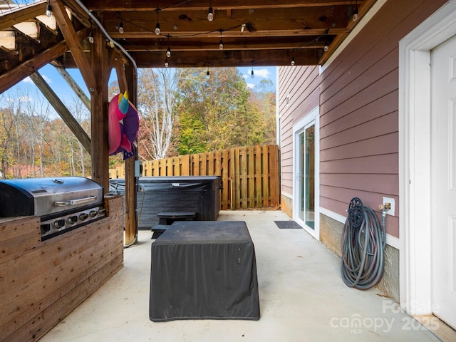 view of patio / terrace featuring a grill and a hot tub