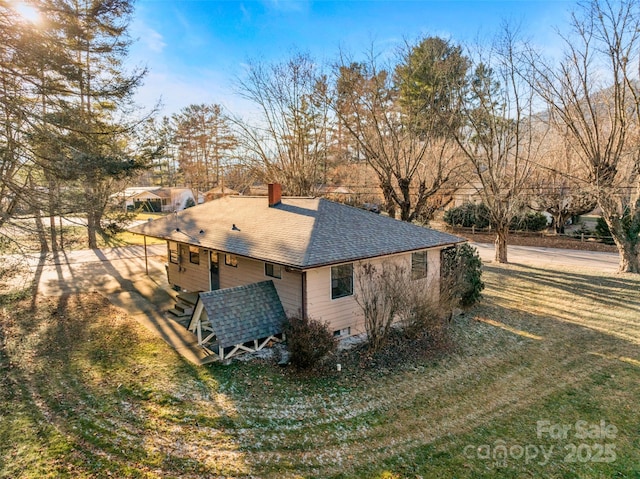 view of side of home featuring a lawn