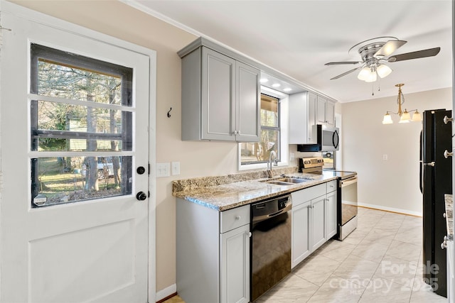 kitchen with black appliances, ceiling fan with notable chandelier, sink, gray cabinets, and light stone countertops