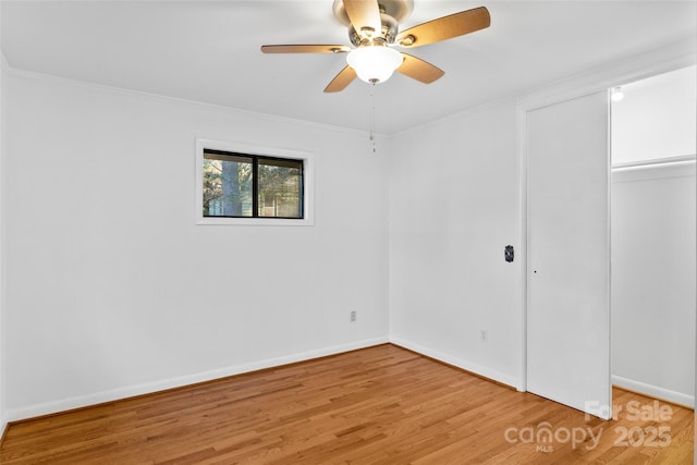 unfurnished room featuring ceiling fan, hardwood / wood-style floors, and ornamental molding