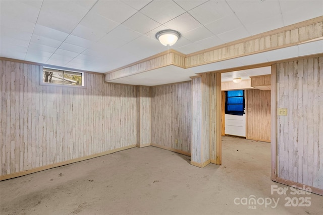 basement featuring wood walls