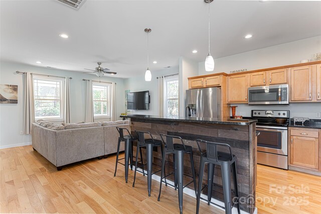 7 Pineview Rd, Fairview, NC 28730 - kitchen with stainless steel appliances, a breakfast bar area, light wood-style floors, recessed lighting, and open floor plan