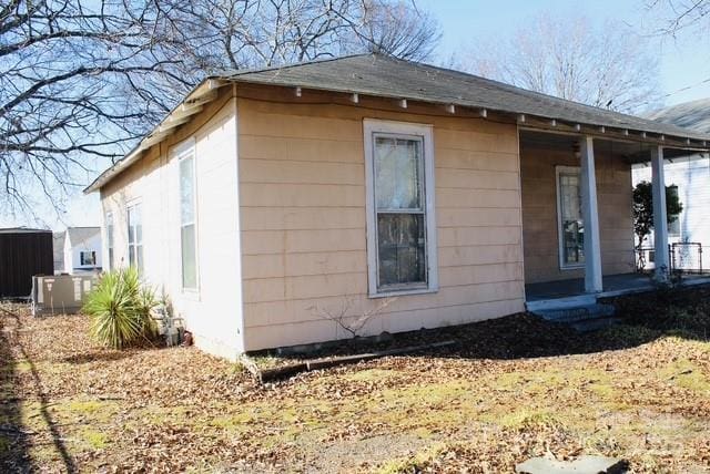 view of side of home with a porch