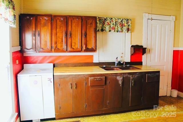 kitchen featuring sink and washer / dryer