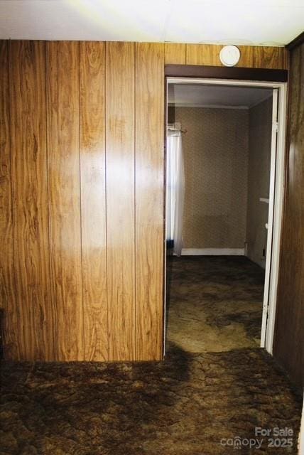 hallway with wood walls