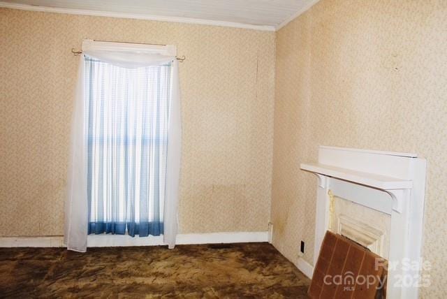 unfurnished living room featuring a fireplace and crown molding