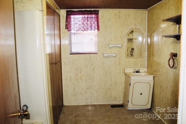 bathroom featuring tile patterned flooring and vanity