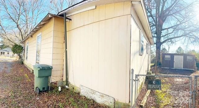 view of side of property with a storage unit