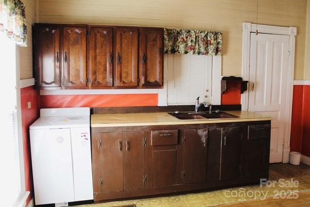 kitchen with washer / clothes dryer and sink